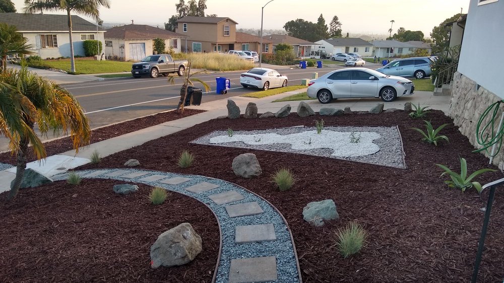 A.G Landscape front yard design with decorative mulch, stones, and walkway in Chula Vista