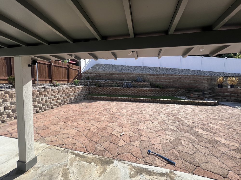 Paver patio with retaining wall and covered pergola by A.G Landscape