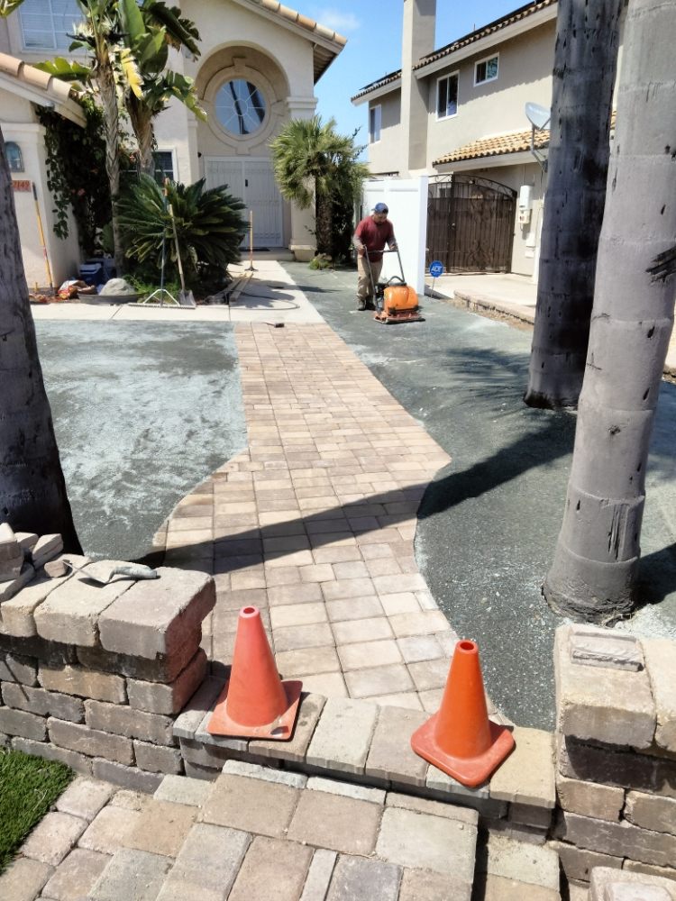 Paver walkway installation in progress at residential property