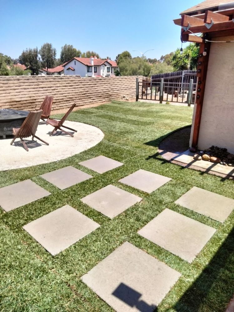 Backyard with stepping stones in turf and pergola by A.G Landscape